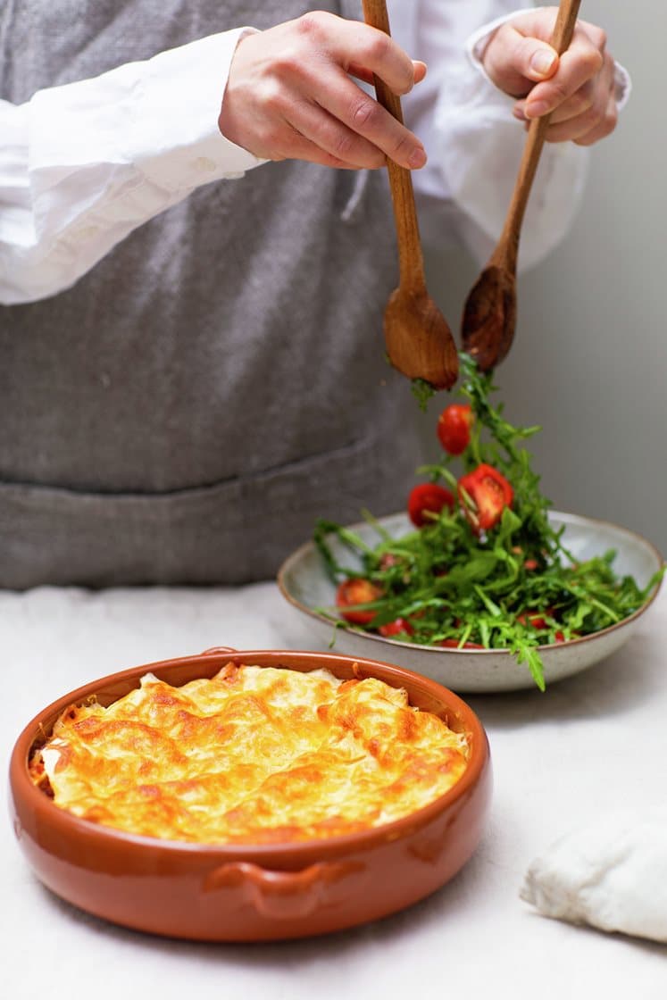 Hjemmelaget lasagne med fersk timian, servert med ruccola- og cherrytomatsalat